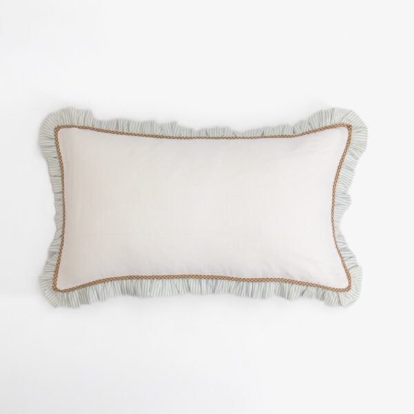 Decorative beige pillow with blue striped ruffle edge and brown trim on a white background, close-up view.
