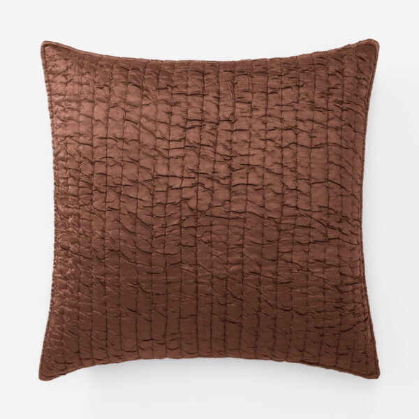 Brown quilted pillow with a diamondsquare stitched pattern on a white background close up