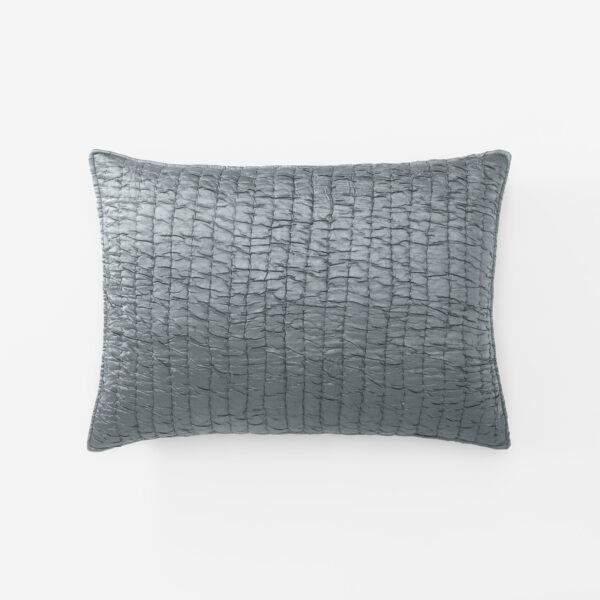 Gray quilted pillow against a white background showing a grid like stitched texture