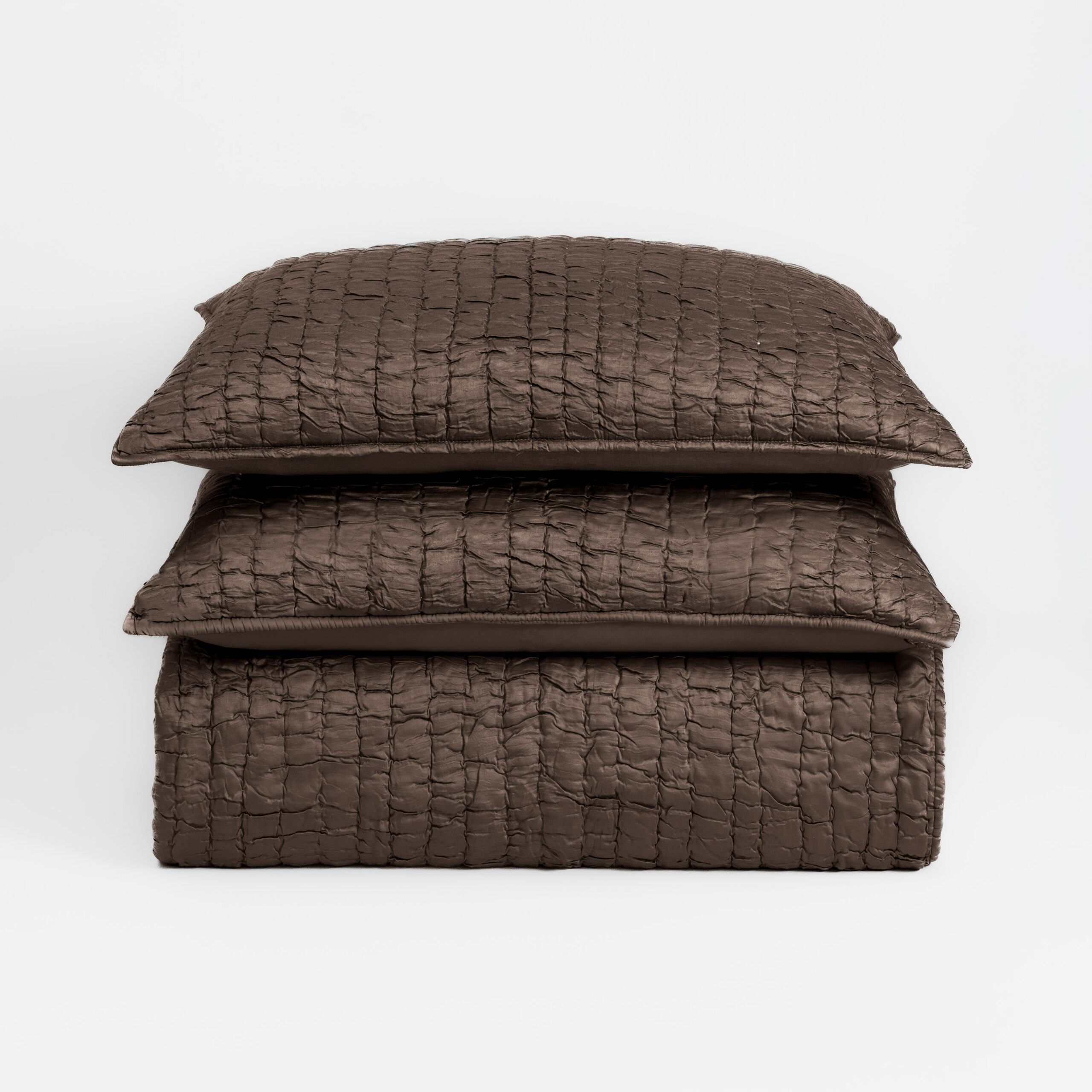 Cc776tbstk1 | Amity Home Stack of brown quilted pillows stacked on a white background to the center of the image