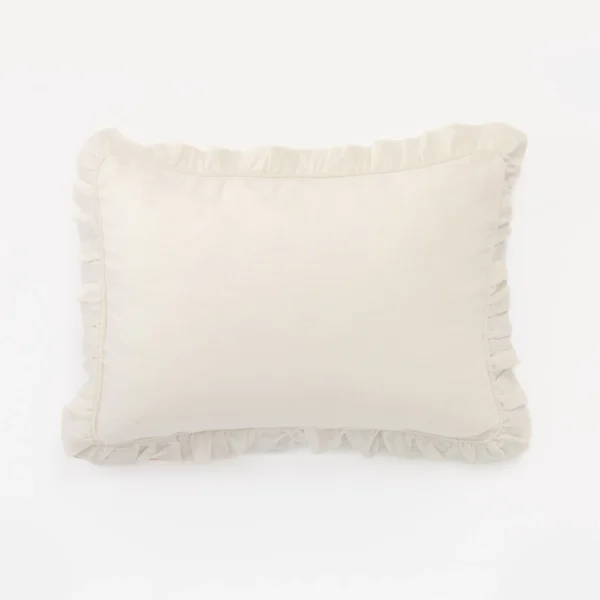 Cream colored cushion with ruffled edges resting on a white background