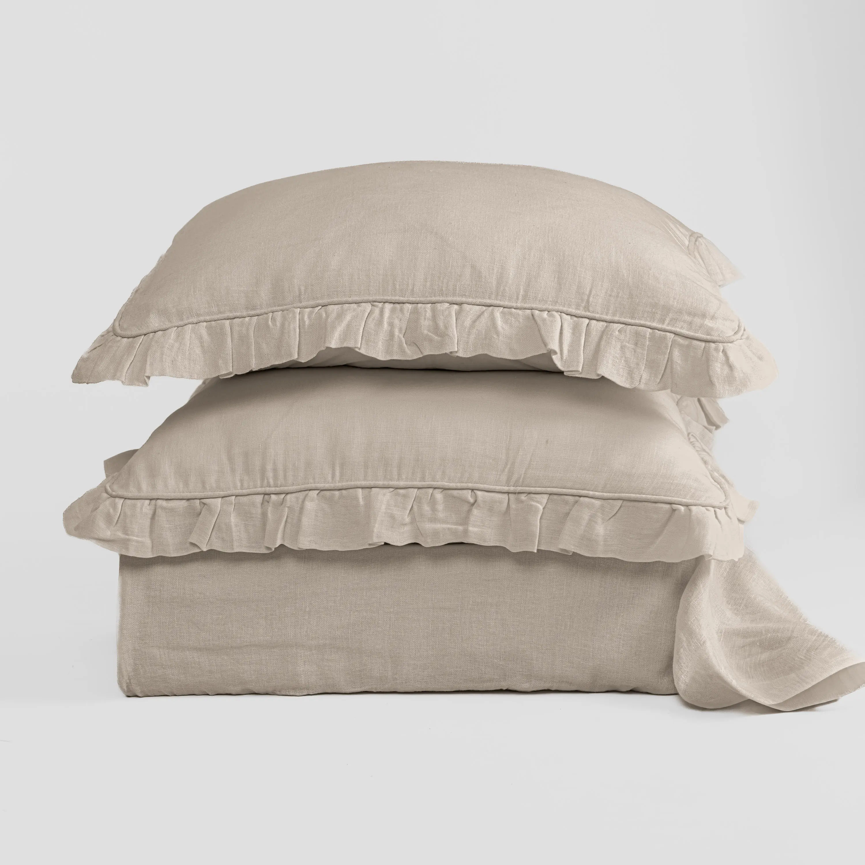 Cc799n3 | Amity Home Stack of beige linen pillows with ruffled edges against a light background