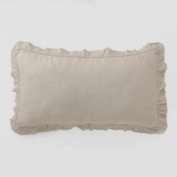 Beige fabric throw pillow with a ruffled edge resting on a white background