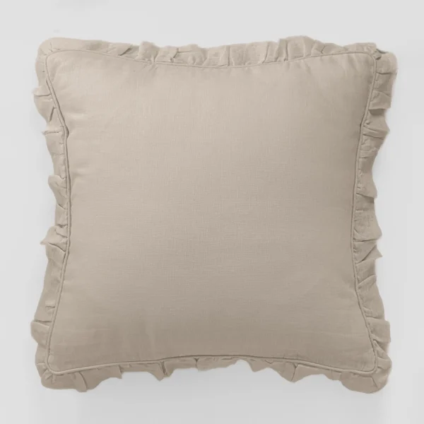 Beige decorative pillow with ruffled edges on a light background