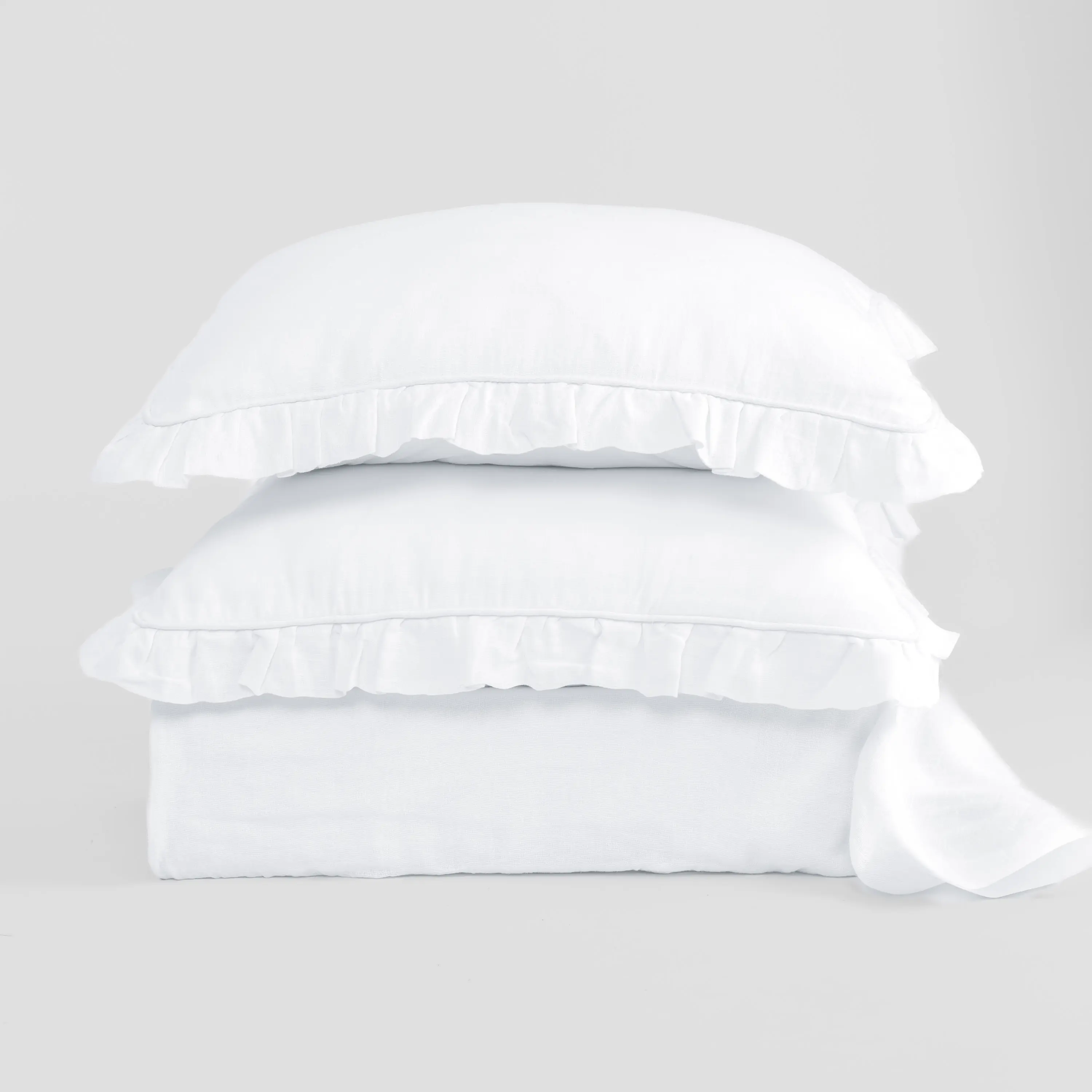 Cc799w3 | Amity Home Stack of white pillows neatly stacked on a light grey background showcasing a soft bedding product