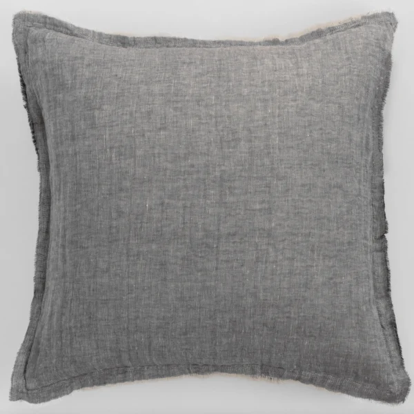Gray woven fabric pillow with frayed edges on a light background close up view of texture and stitching