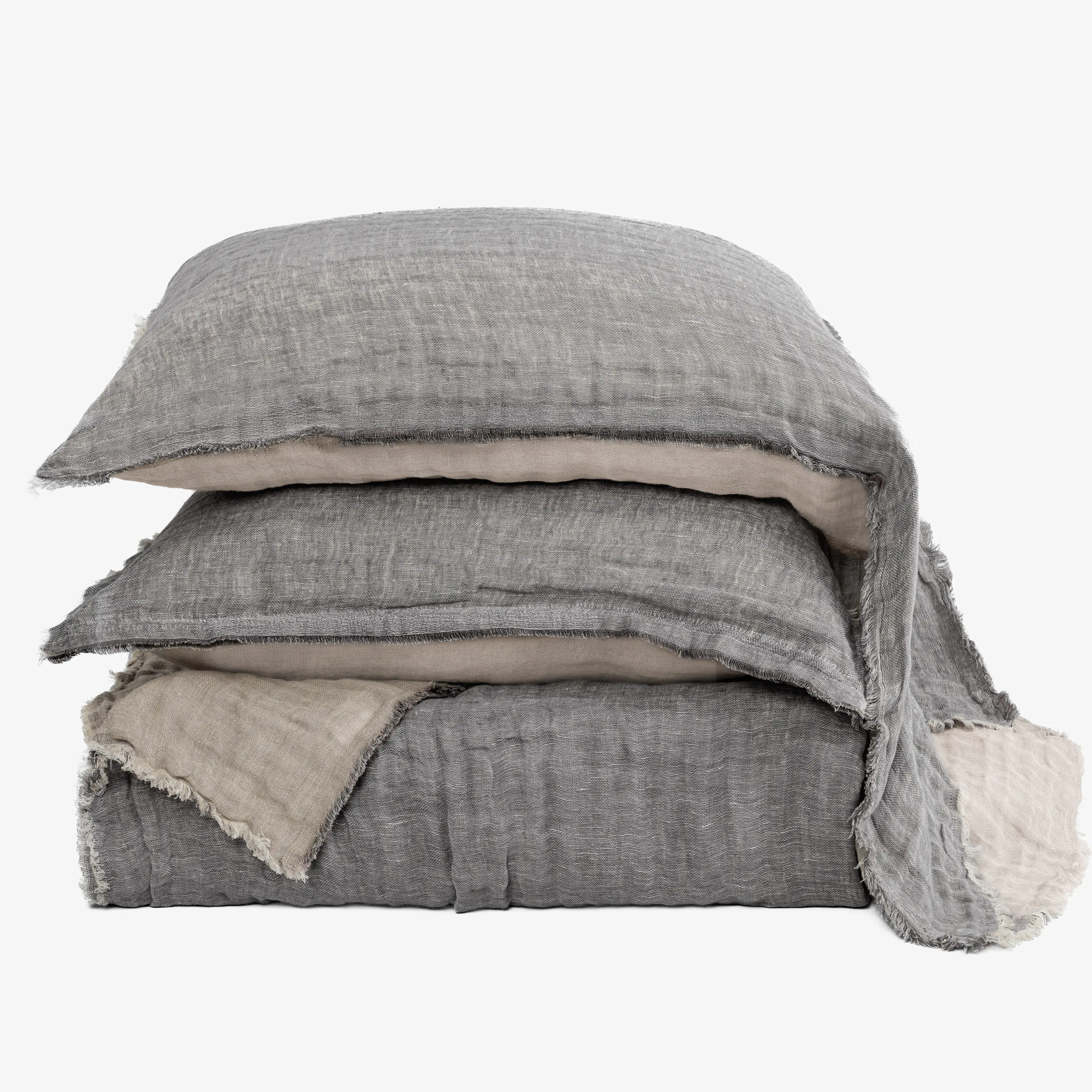 Cc926a20 | Amity Home Stack of gray denim pillows with frayed edges stacked on a white background