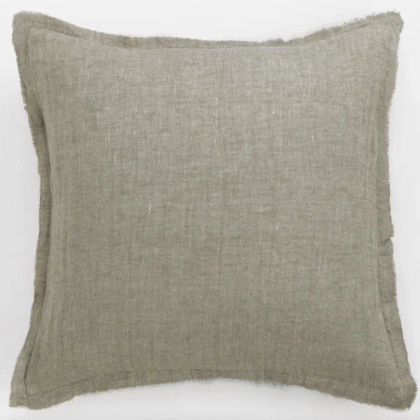 Beige linen throw pillow with frayed edges lying flat on a white surface