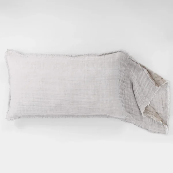 A light gray linen fabric draped along the bottom edge of a white background folded at the right corner