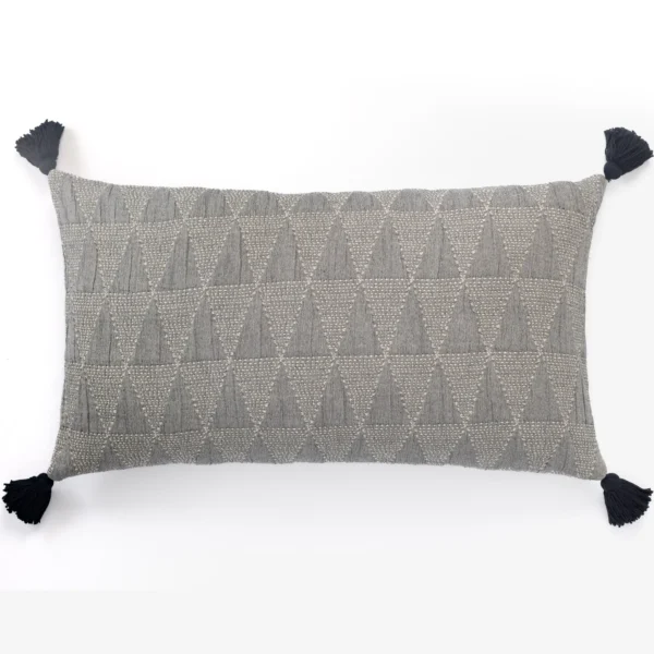 Grey textured decorative cushion with geometric pattern and black tassels at each corner on a white background