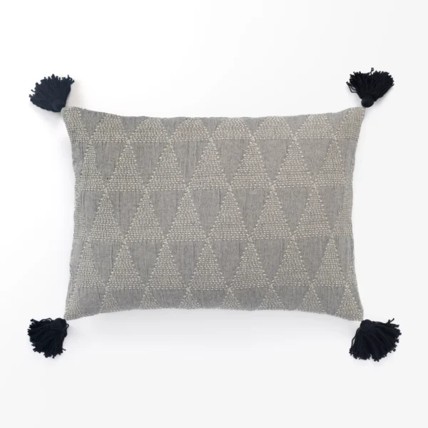 Gray woven cushion with a repeating diamond pattern and black tassels at the corners on a white backdrop