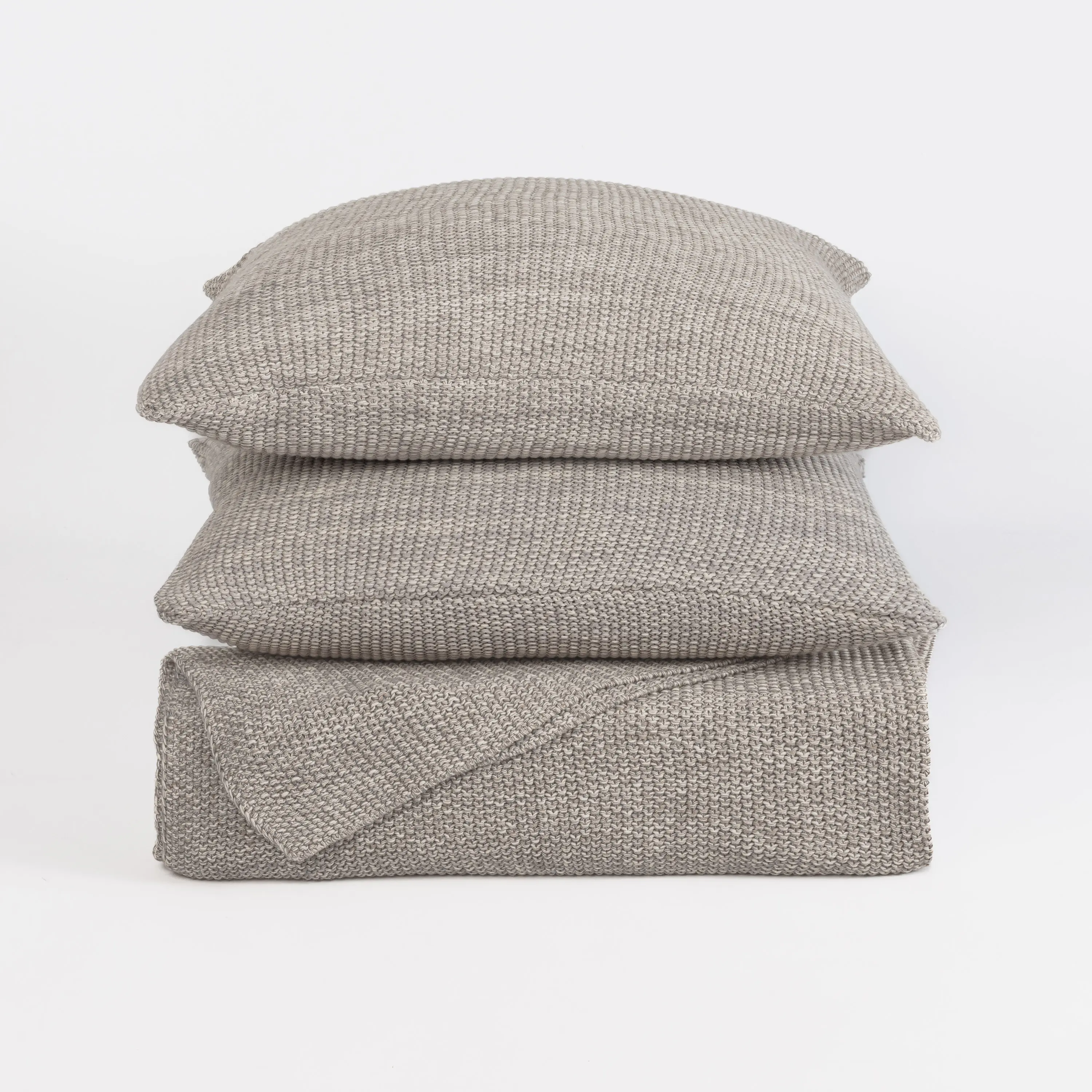 Kd2002gstk10 V2 | Amity Home Stack of light gray knitted throw pillows stacked on a white background with a chunky knit pattern