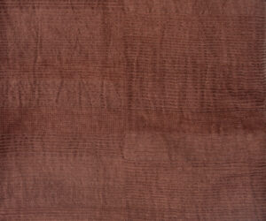 Close up of brown terrycloth fabric with textured loops and subtle horizontal stripes