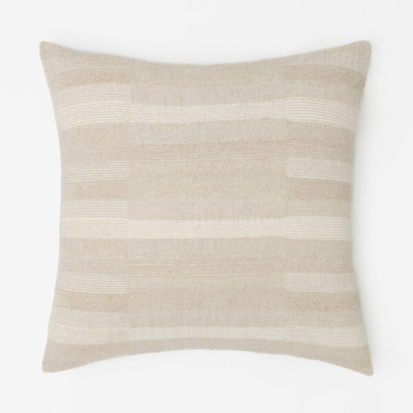 Beige striped pillow on a white background close up of fabric texture