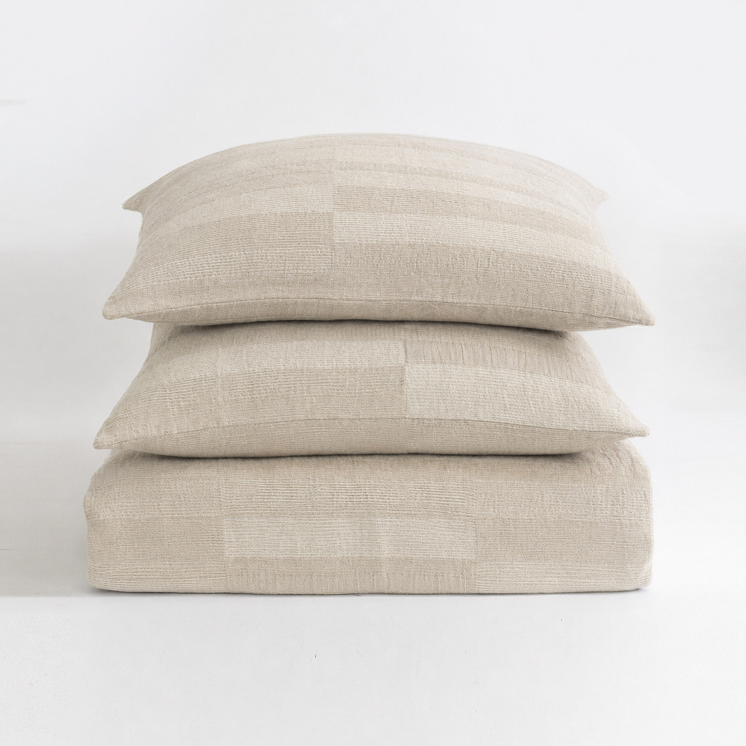 15548nstk6 | Amity Home Stack of three beige textured throw pillows stacked on a white surface httpsexample Com