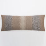 Partial view of a woven pillow with brown and beige stripes along the bottom edge against a white background decorative image