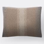Decorative throw pillow in beige brown fabric with a subtle geometric stitch pattern along the center edge to edge alignment