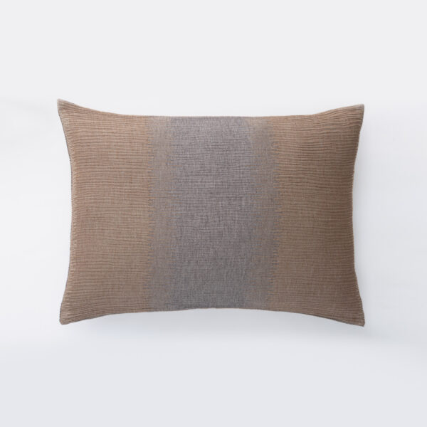 Brown textured cushion resting on a white background shown from the top edge of the pillow
