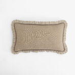 Beige throw pillow with striped ruffle trim along the bottom edge on a white background