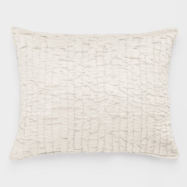 Cream-colored quilted pillow with a grid of stitched squares on a white background.