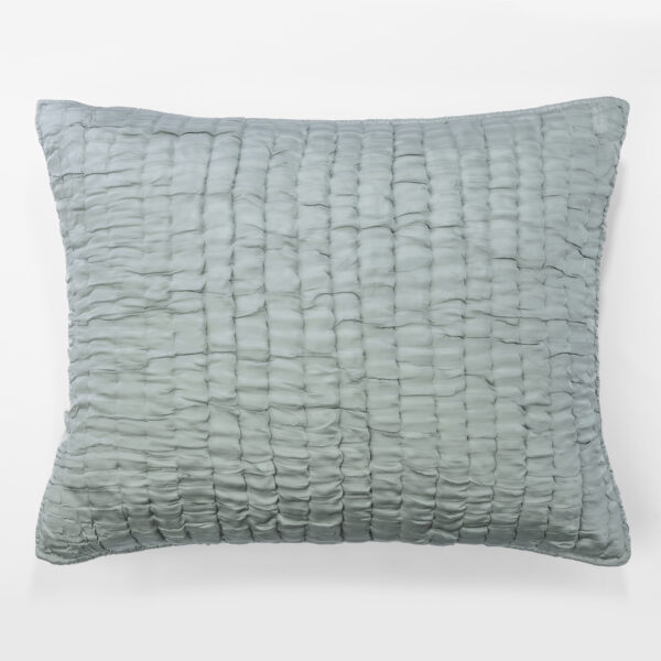 Close-up of a light blue quilted pillow against a white background, showing a grid of stitched squares.