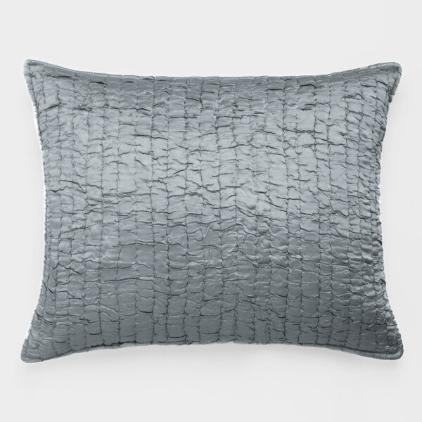 Close-up of a large gray quilted pillow with a textured, gridlike pattern on a light background.