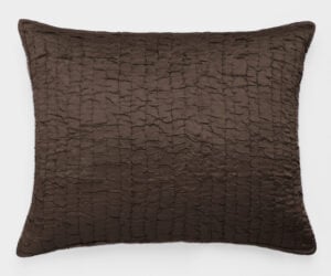 Brown quilted decorative pillow photographed against a white background showing a rectangular stitched pattern and soft texture