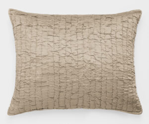 Beige textured pillow with square tufted pattern on a white background