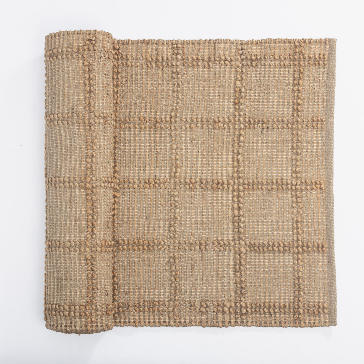 Close up of a beige woven fabric with raised beaded stripes and intricate texture on white background