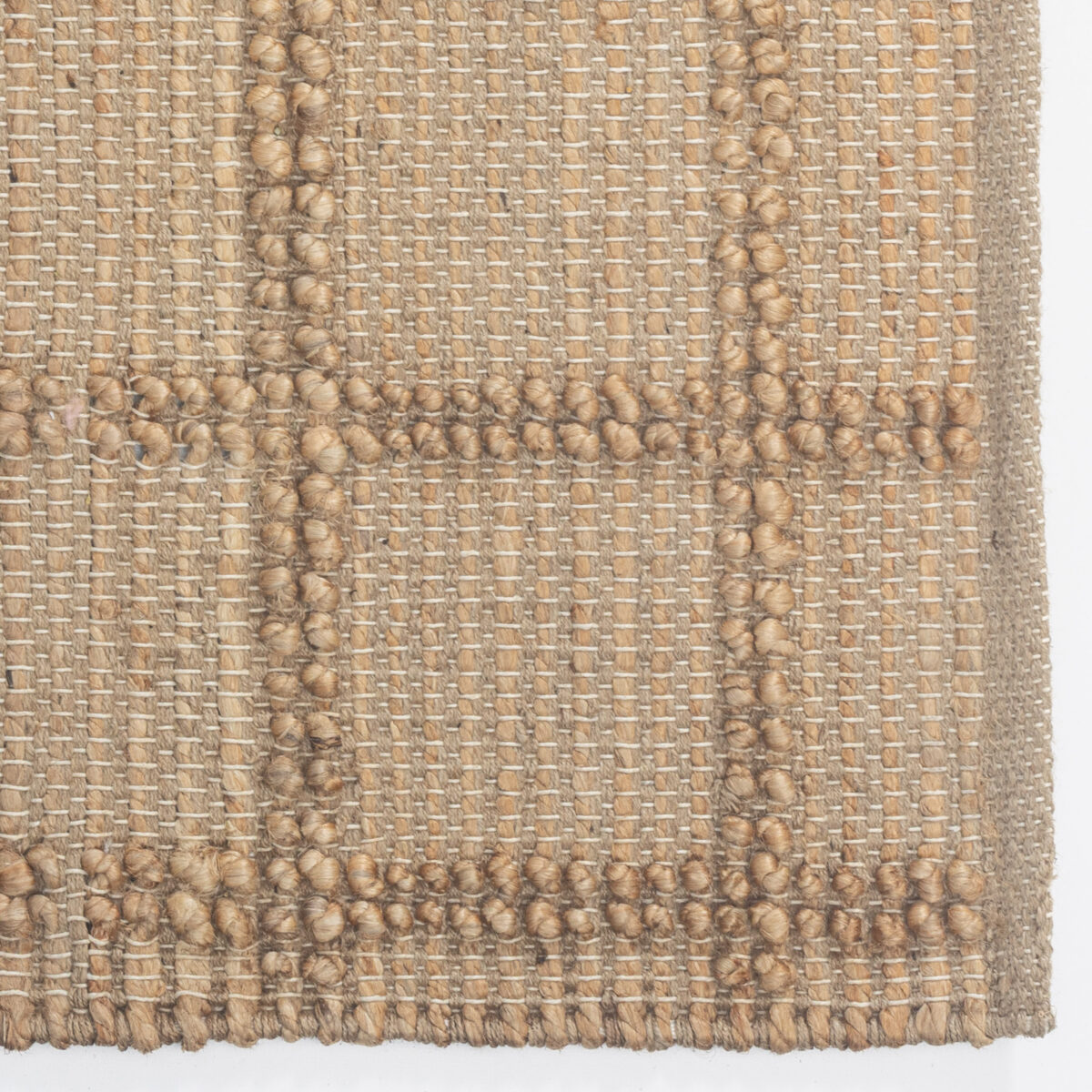 Close up of a beige woven fabric with chunky knobby yarn accents
