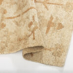 Beige knitted rug folded to show thick woven texture and edges