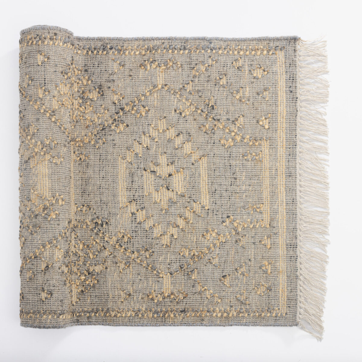 Gray woven rug with subtle cream decorative stitching and fringe along the right edge photographed flat