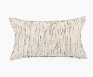 Close up of a beige striped decorative pillow against a white background