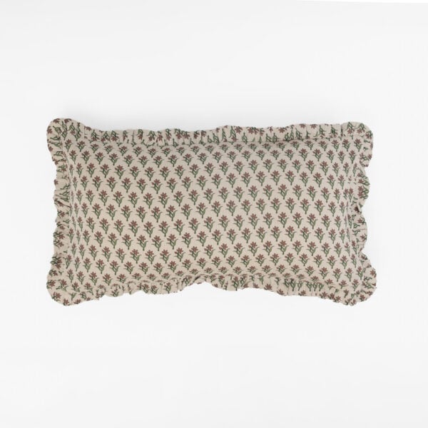 Beige fabric with a repeating red flower and green stem pattern along the bottom edge, set against a white background.