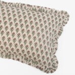 Beige fabric with a repeating pattern of orange flowers and green stemsleaves across the surface
