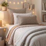 Cozy bed with patterned pillows and striped quilt string lights plant and books on a shelf in soft warm lighting