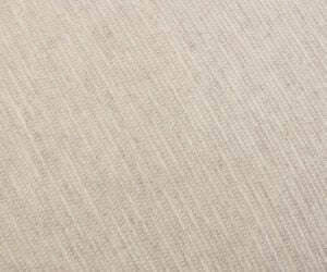 Close up of beige woven fabric with a diagonal rib pattern