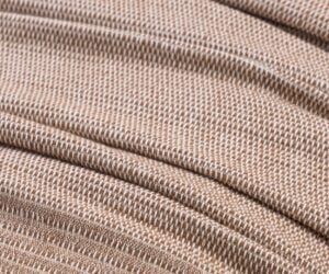 Close up of brown woven fabric showing a tight twill texture