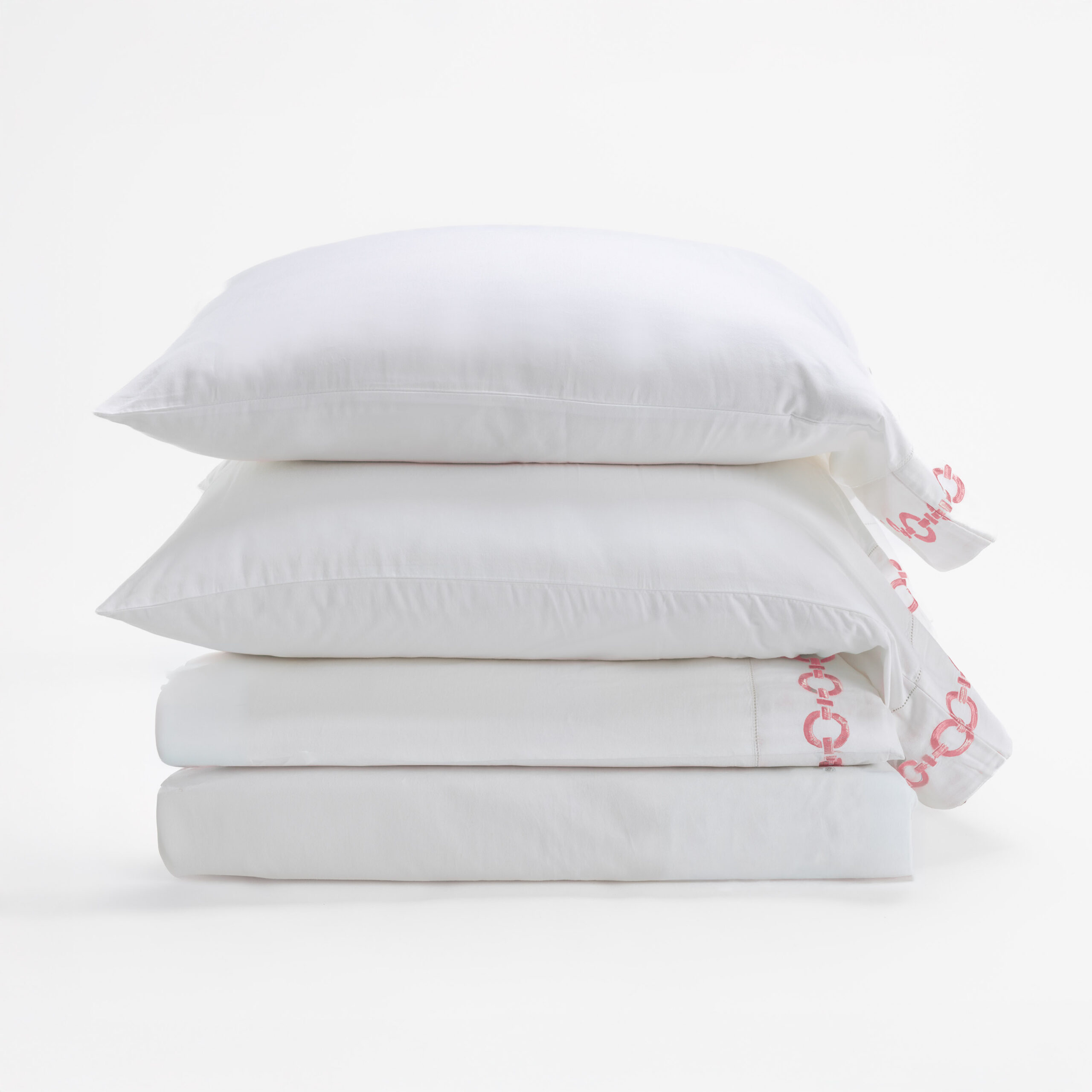 17201s 42 | Amity Home Stack of white pillows stacked in a bright minimal setting with packaging showing red lettering on the side
