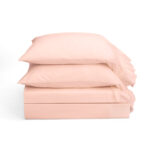 Stack of light pink pillows on a white background