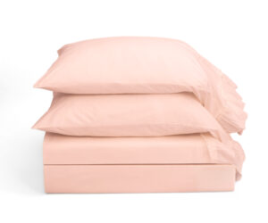 Stack of light pink pillows on a white background