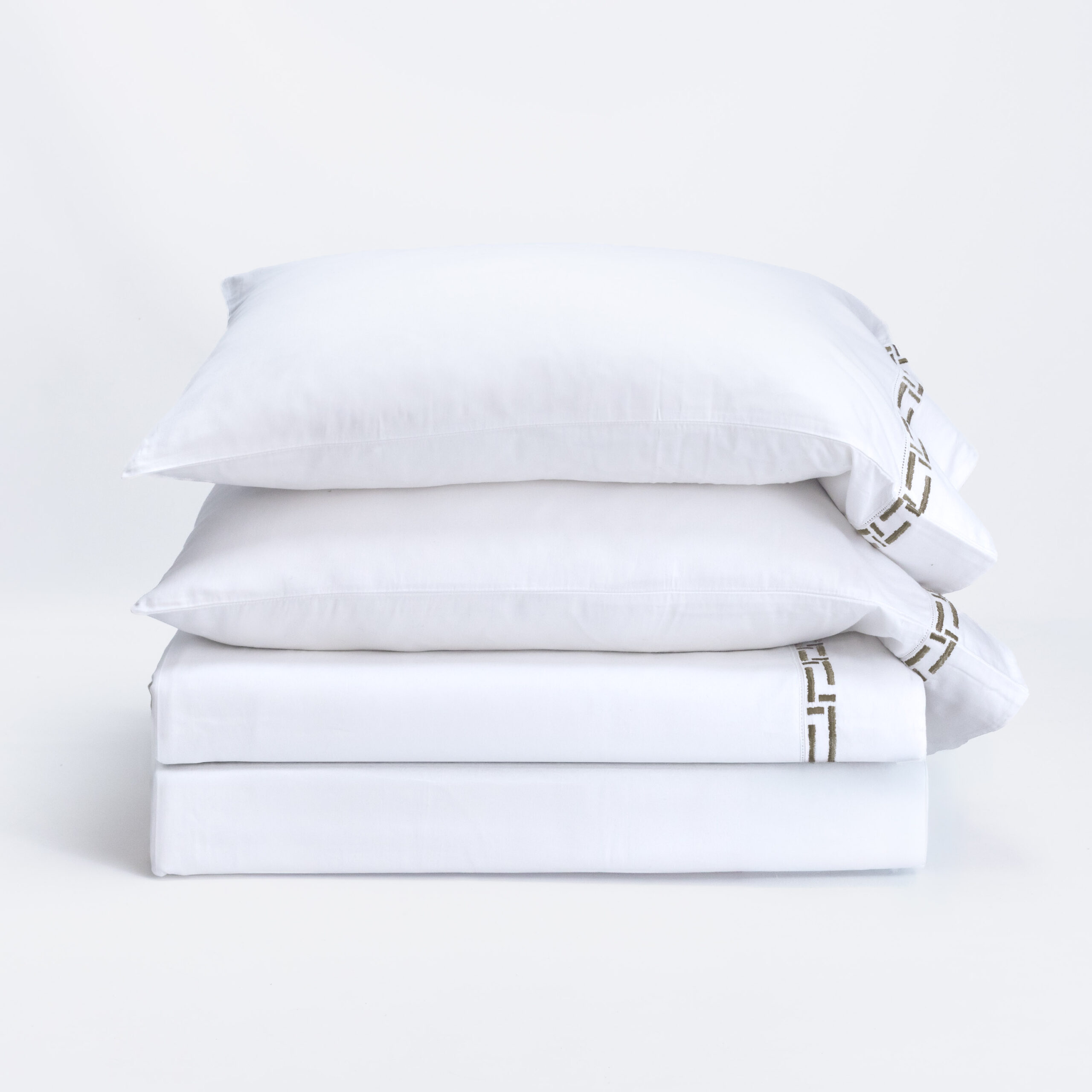 17212c 17 | Amity Home Three white pillows stacked on a white surface against a plain white background soft and clean look