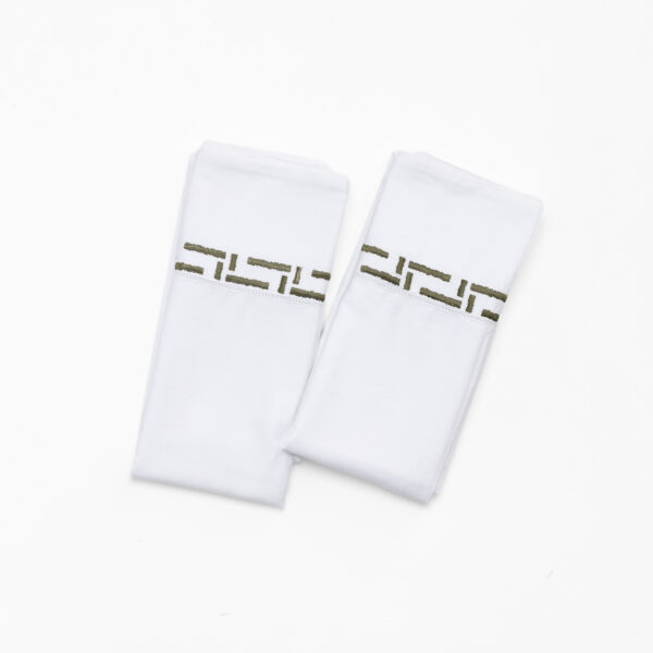 Two white socks with brown stitching partially visible on a white background