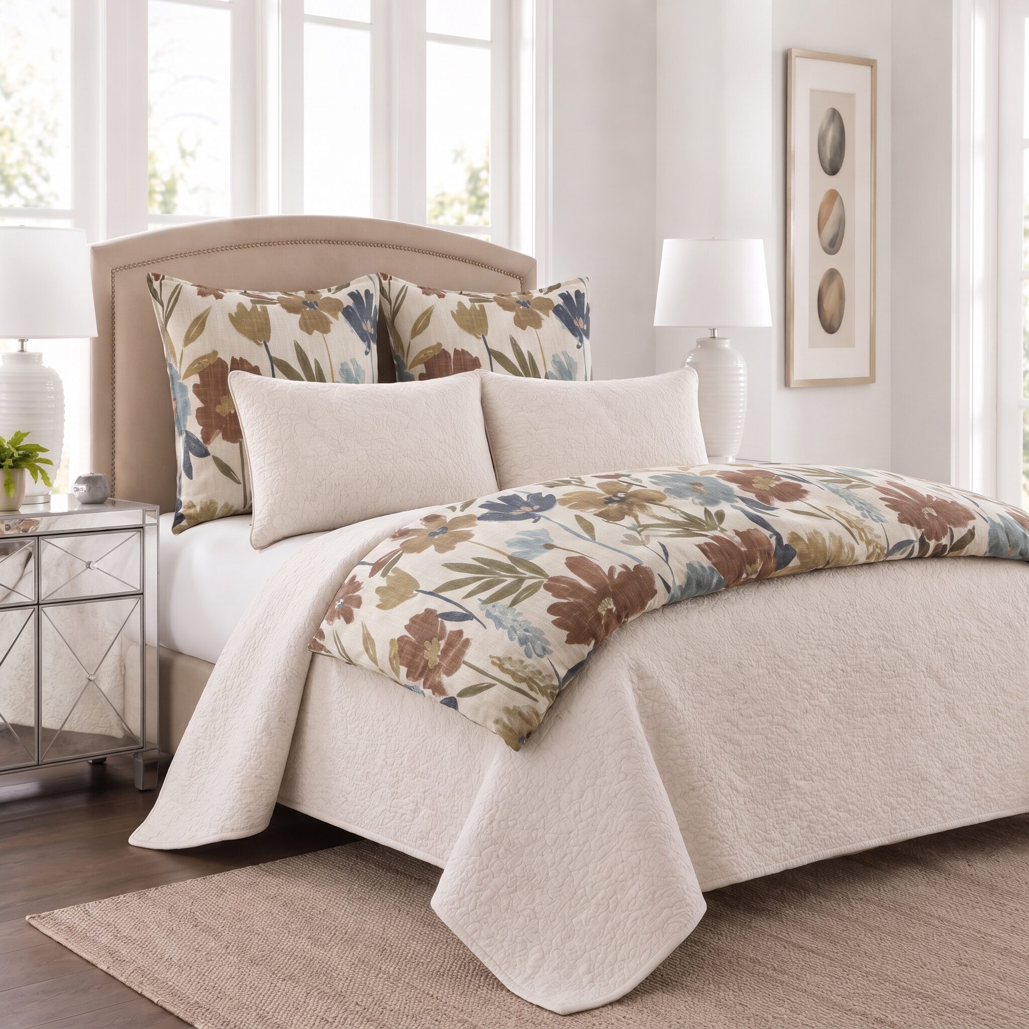 Adair Bed Pouf | Amity Home Beige upholstered bed with floral patterned pillows and cream quilted bedding in a bright bedroom