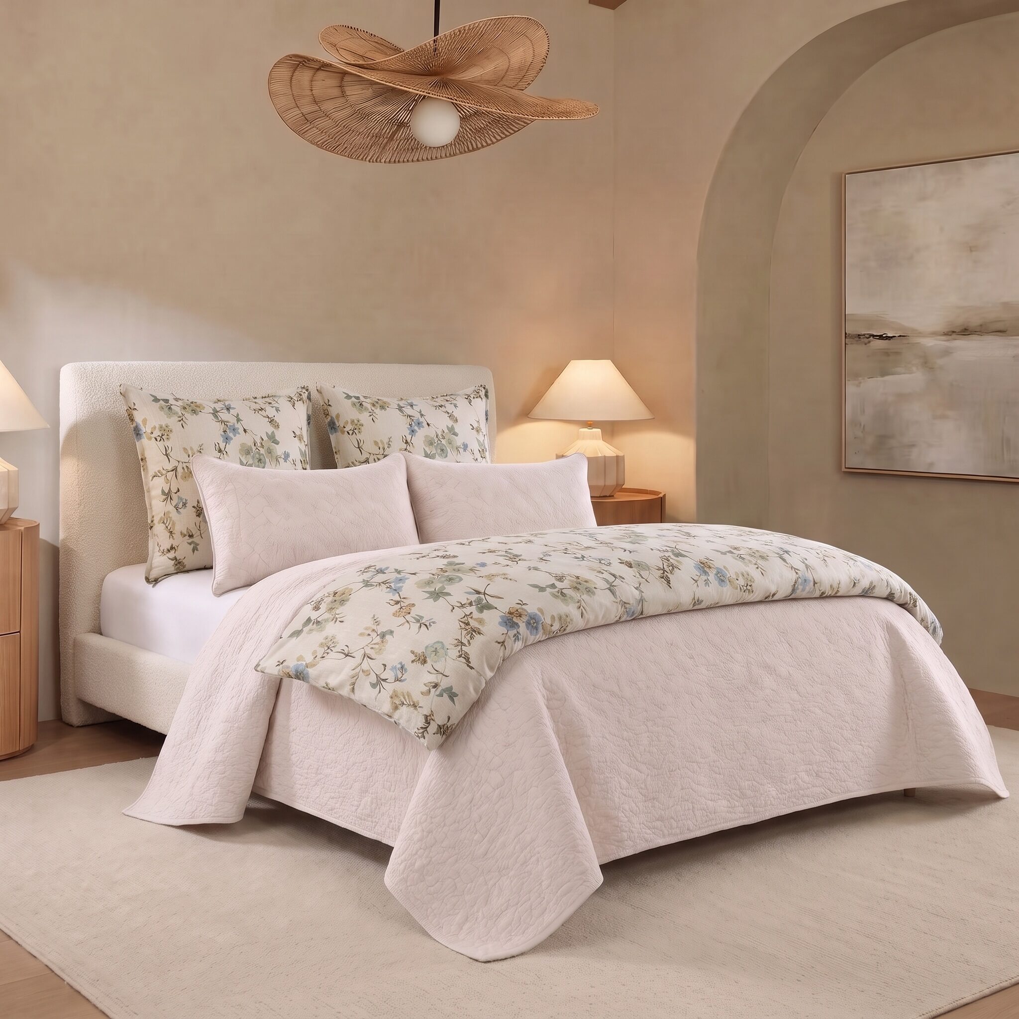 Elissa Bed Pouf | Amity Home Bedroom with a white upholstered bed floral pattern pillows and a soft beige palette lamps on either side and a woven pendant light overhead