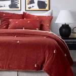 Amity home hawke quilt in brick   velvet with decorative tassels