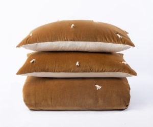 Amity home hawke quilt in ochre   velvet with tassel tufts