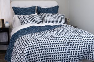 Amity home luna quilt in indigo   geometric starburst pattern