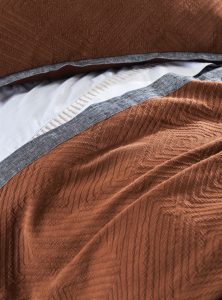 Amity home hector x long bolster in terracotta   woven chevron texture