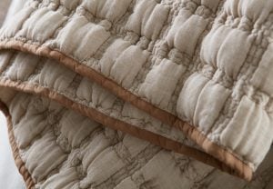 Amity home claudia  hammond collection in natural beige with brown trim   puffy quilted texture